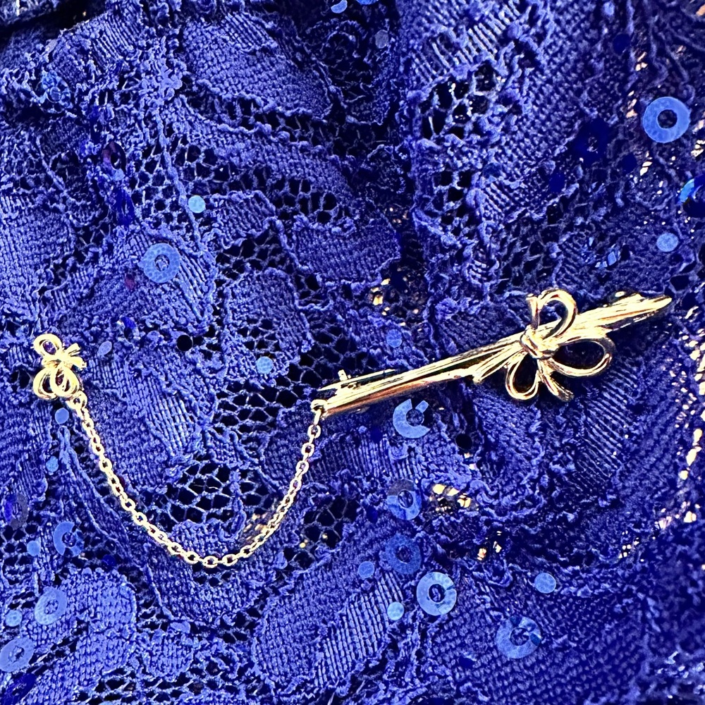 Elegant Silver Tone Bow Brooch with Chain